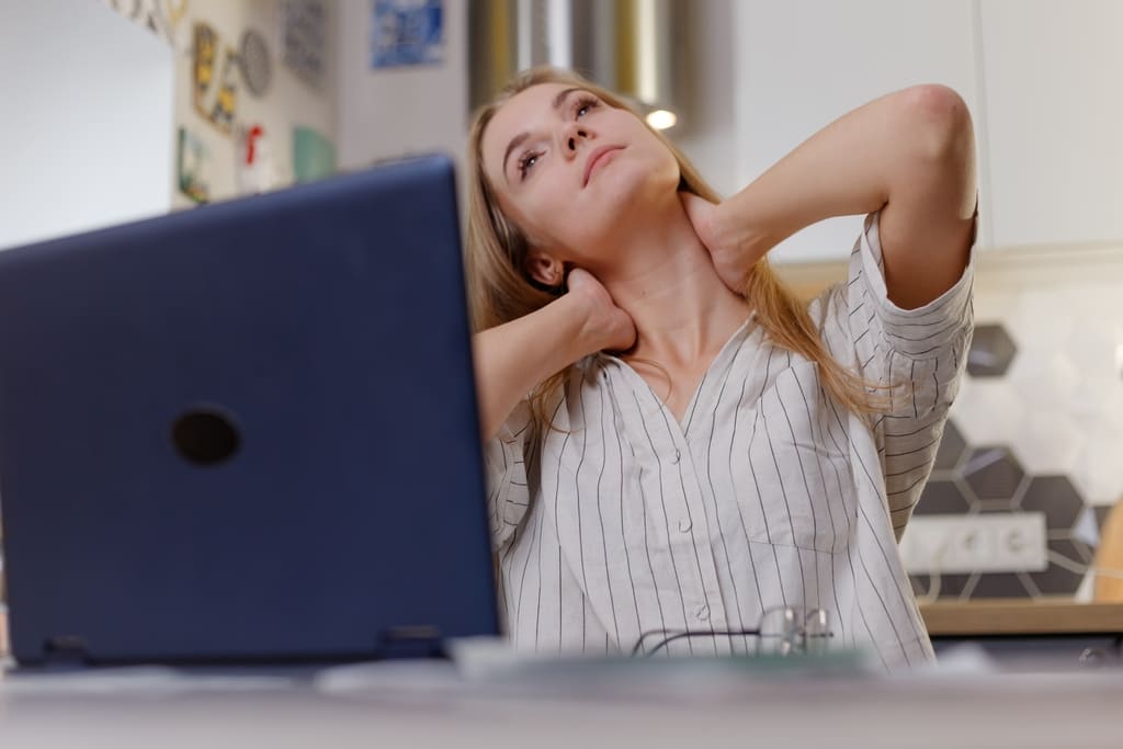 woman holding her neck feeling neck pain