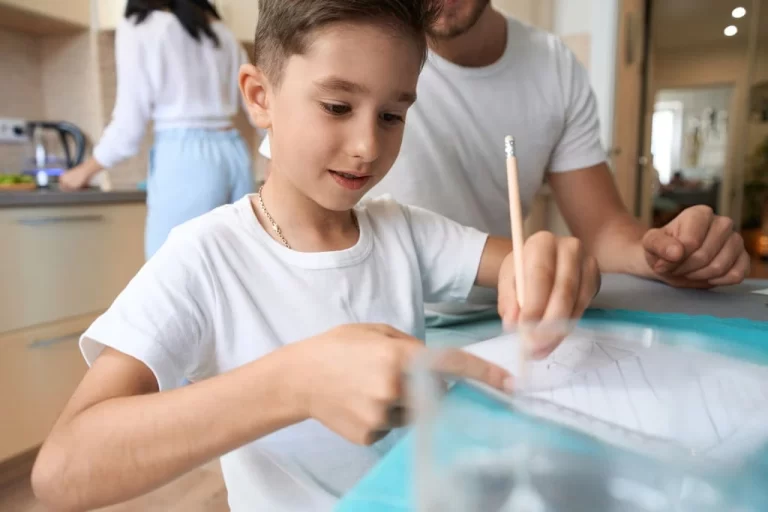 boy with dysgraphia trying to write