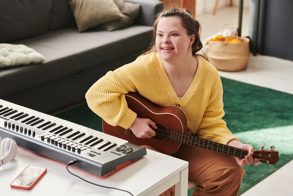 cheerful girl with down syndrome playing guitar 2022 05 25 00 52 05 utc 1