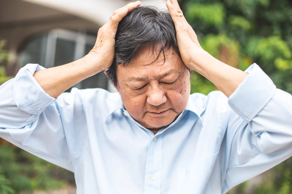 elder man having headache before seizure
