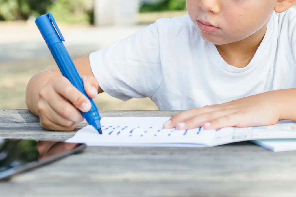 kid with dysgraphia writing