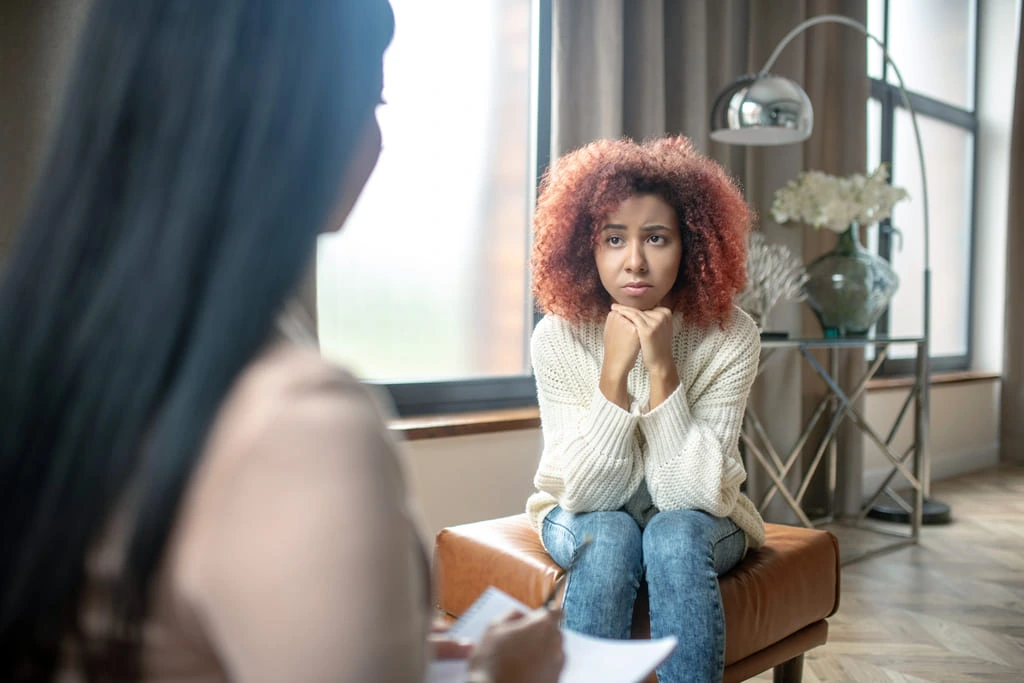 woman feeling confused while sitting and answering questions