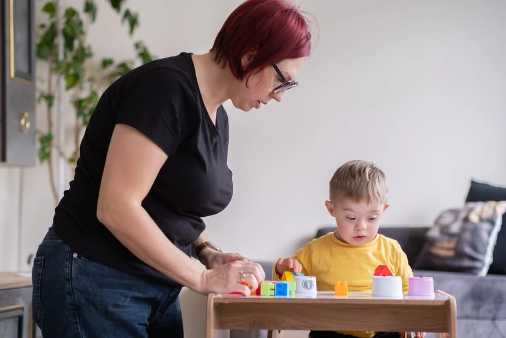 learning disability support worker helping a child with learning disabilities