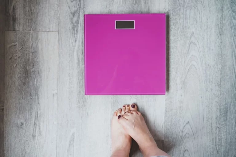 shy feet in front of a scale