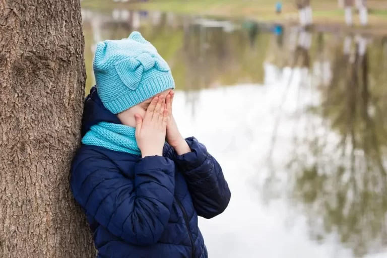 autistic kid hiding her face