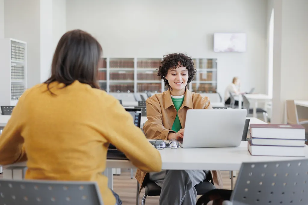 two women in library or coworking are sitting oppo 2022 12 18 18 49 30 utc 2
